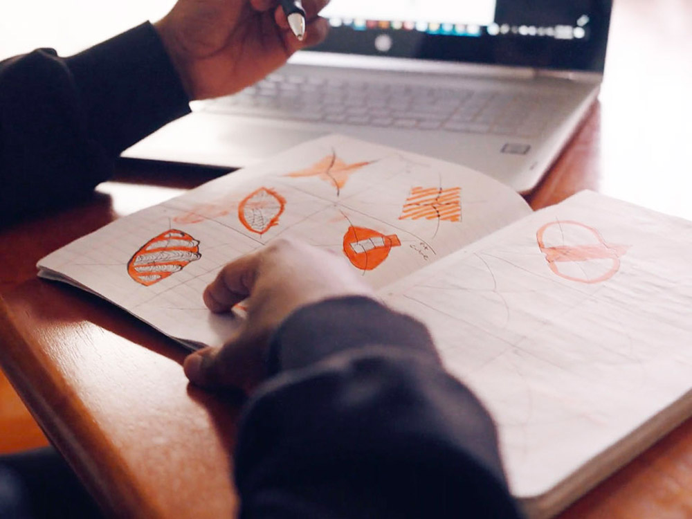 hands drawing in a sketch book