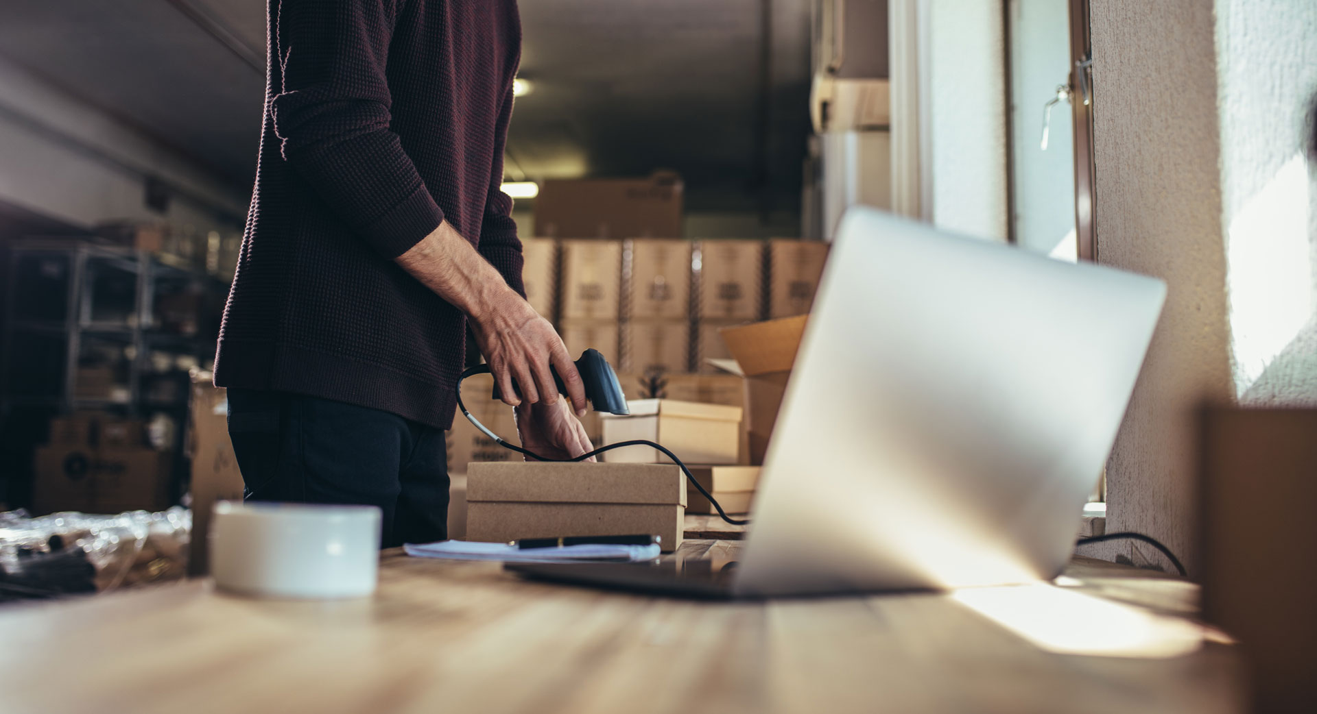 man scanning a bar code on a box